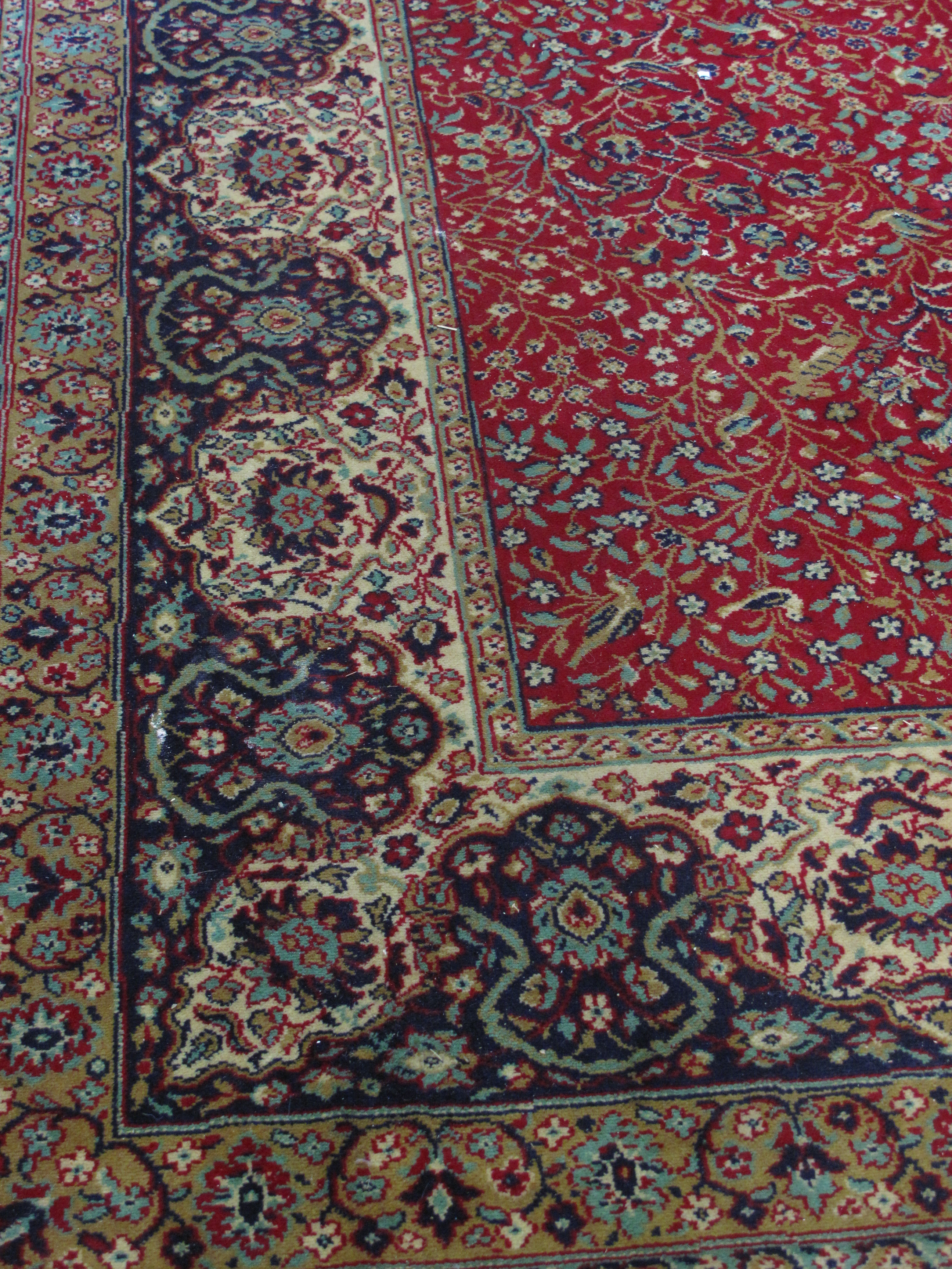 Large Persian design red ground foliate decorated Wilton carpet.