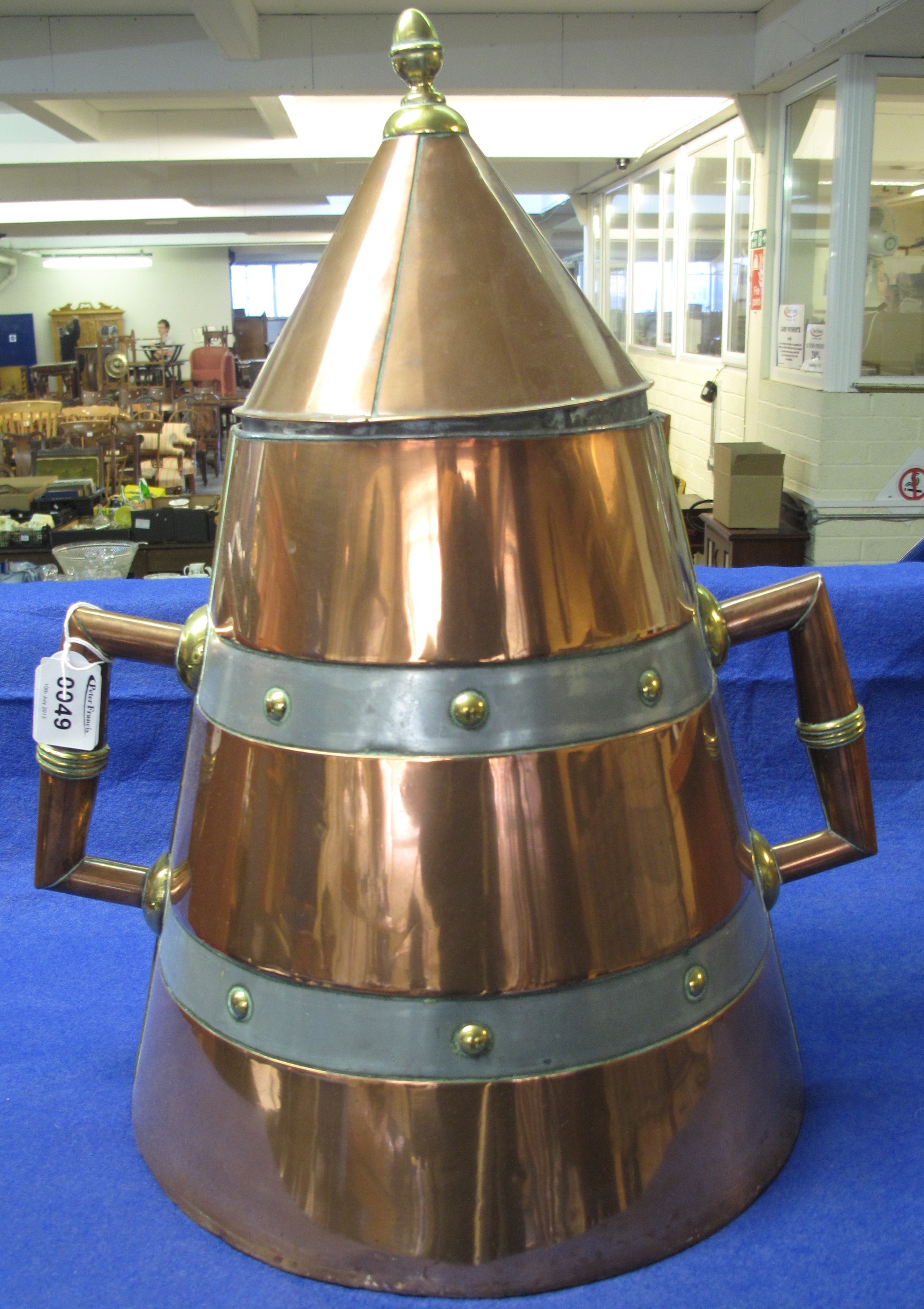 Large copper conical shaped two handled  storage container with conical cover.