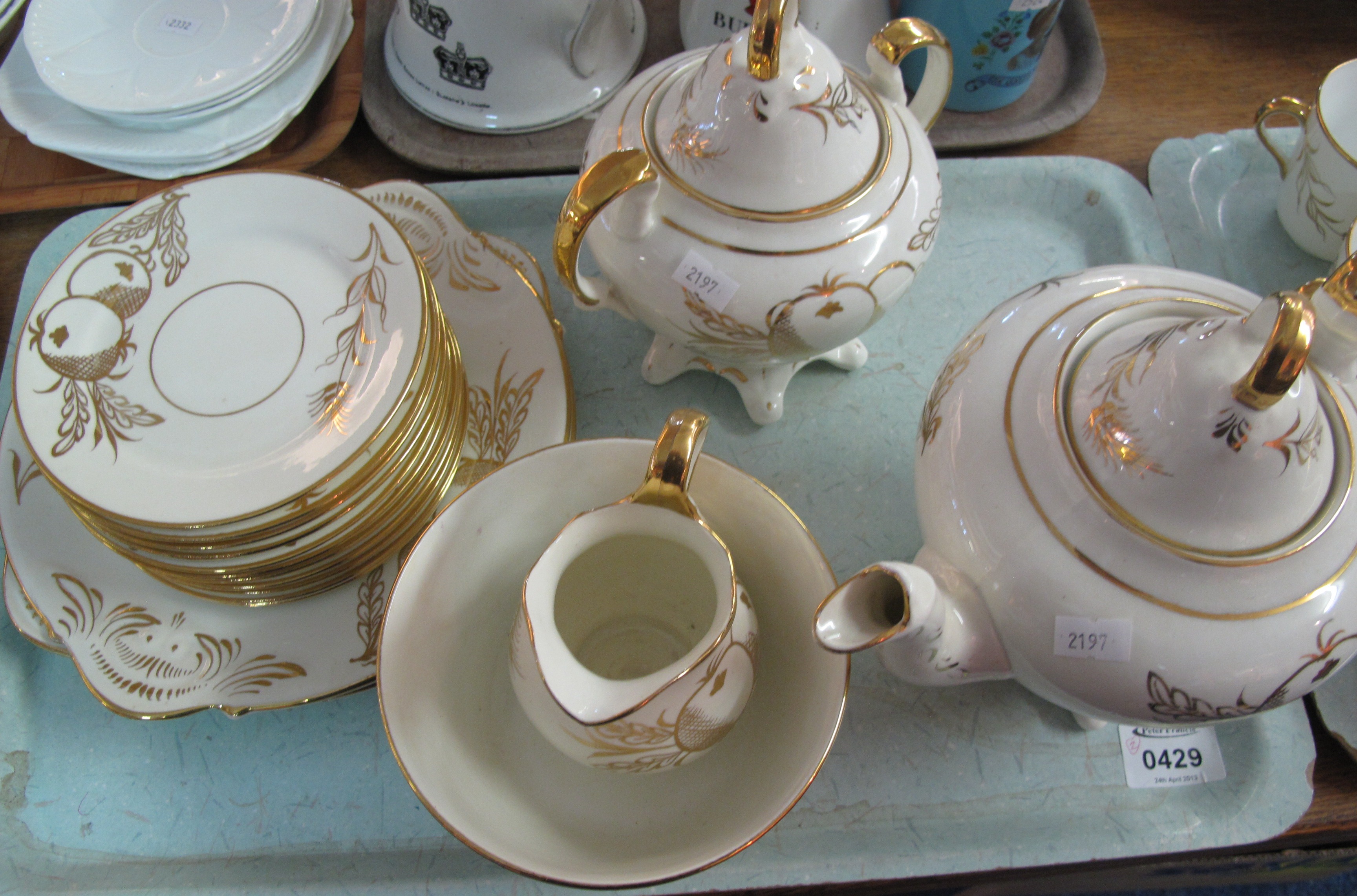 Two trays of Staffordshire white ground overall decorated with borders handles, fruits, part teaware