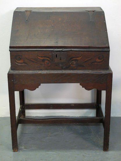18TH CENTURY OAK CLERKS DESK ON STAND, having slope front with  iron hinges, foliate scrolled inlaid
