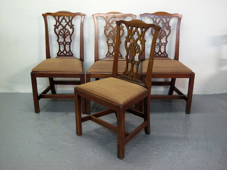 A SET OF FOUR 18TH CENTURY CHIPPENDALE STYLE  MAHOGANY  DINING CHAIRS, having shaped top rails above