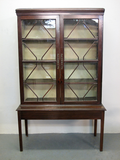 GEORGIAN STYLE MAHOGANY BOOKCASE CABINET ON STAND, having moulded cornice over two astragal glazed