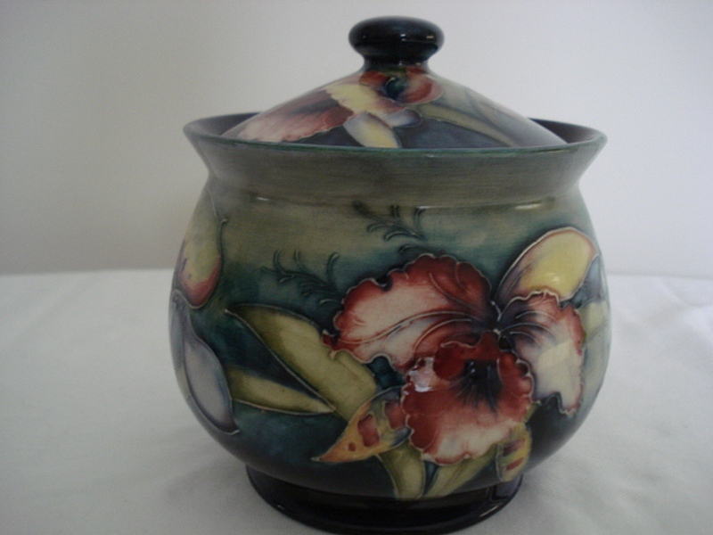 An early Walter Moorcroft lidded jar and cover, form decorated in the frilled or slipper Orchid