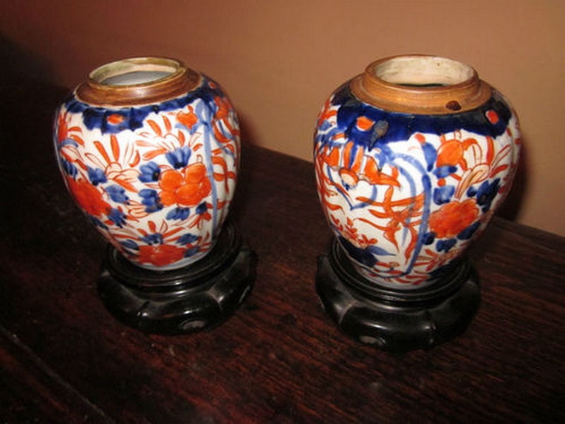 A pair of Victorian era Imari vases, each of fluted baluster form with characteristic decoration of