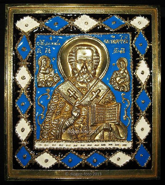 Russian, a 19th.Century brass Icon of St.Nicholas, decorated with three colours of enamel, 11cm x