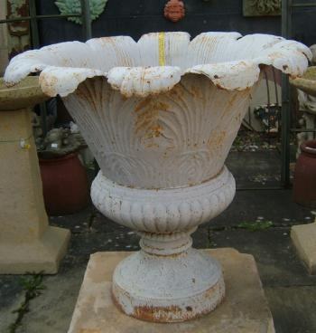 A very large cast iron urn with pattern to rim shaped body by its scroll and foliate designs