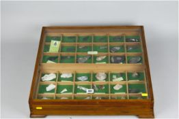 A cased collection of flint arrow-heads and Neolithic flint flakes, all labelled together with a