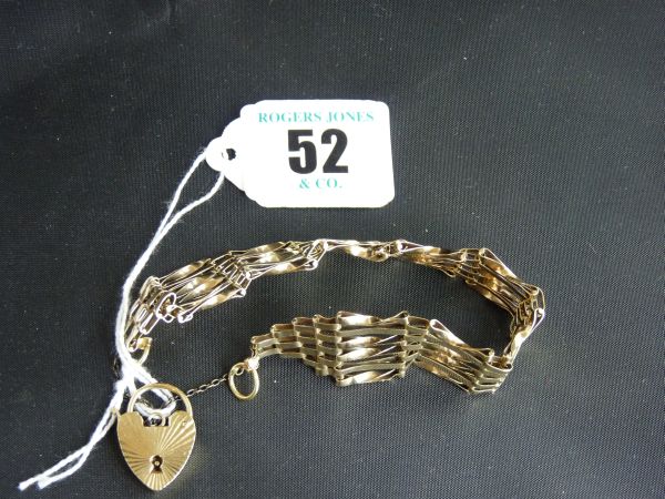Jewellery.  A 9 carat gold six-bar Gate bracelet with sunburst- patterned 9 carat padlock and safety