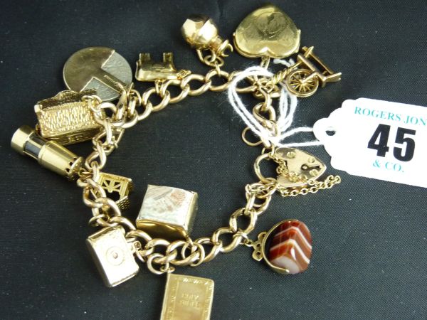 Jewellery.  A 9 carat gold link bracelet and padlock with approximately 12 charms; 38 grms.