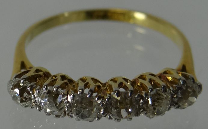 An 18ct yellow gold ring with a row of six diamonds