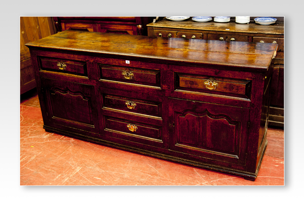 A well coloured 18th Century oak sideboard/dresser base having three top narrow opening drawers with