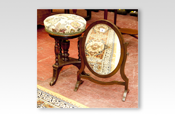 An oval mahogany toilet mirror and an Edwardian piano stool with tapestry revolving seat