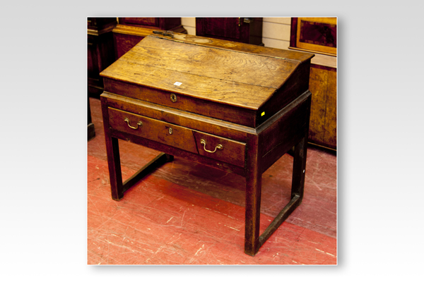 A late 18th/early 19th Century oak merchant`s/lawyer`s type desk having a shallow slope front with