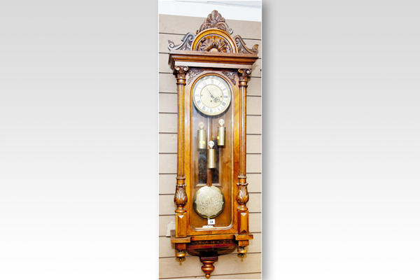 A fine quality walnut encased Vienna wall clock having a carved and domed pediment with twin side