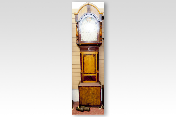 A 19th Century oak and mahogany longcase clock having a domed and arched hood with turned pillars,