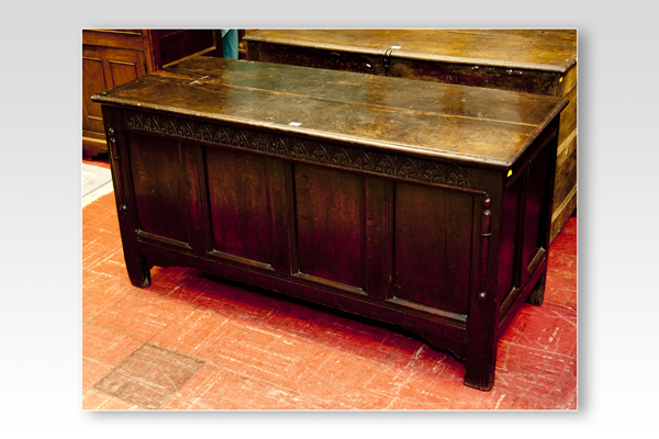 An 18th Century oak dower chest having a narrow lunette top panel over four inset panels, 56 ins (