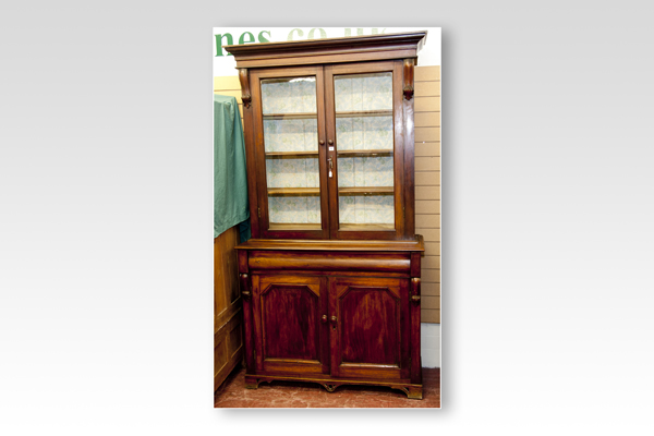 A Victorian mahogany two door bookcase cupboard having two glazed upper doors to a base of one