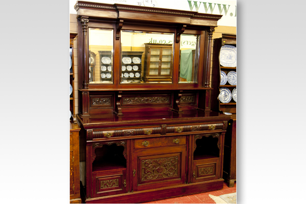 An Edwardian mahogany mirror backed sideboard, the top having three bevelled mirrors over a