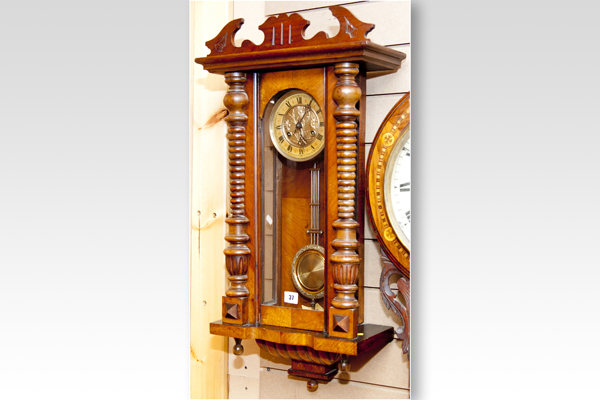 A small walnut encased Vienna pendulum clock