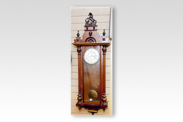A walnut encased twin weight Vienna pendulum wall clock