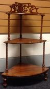 A three tier mahogany what-not with twist-carving to the columns and a fretted top-gallery
