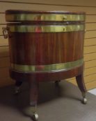 An eighteenth century oval mahogany brass banded wine cooler with oval ring handles on square