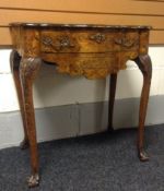 An eighteenth century Dutch walnut and floral maquetry lowboy having a serpentine front and having a