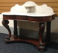 A marble-top mahogany wash-stand on acanthus and scrolling cabriole supports, above a shaped