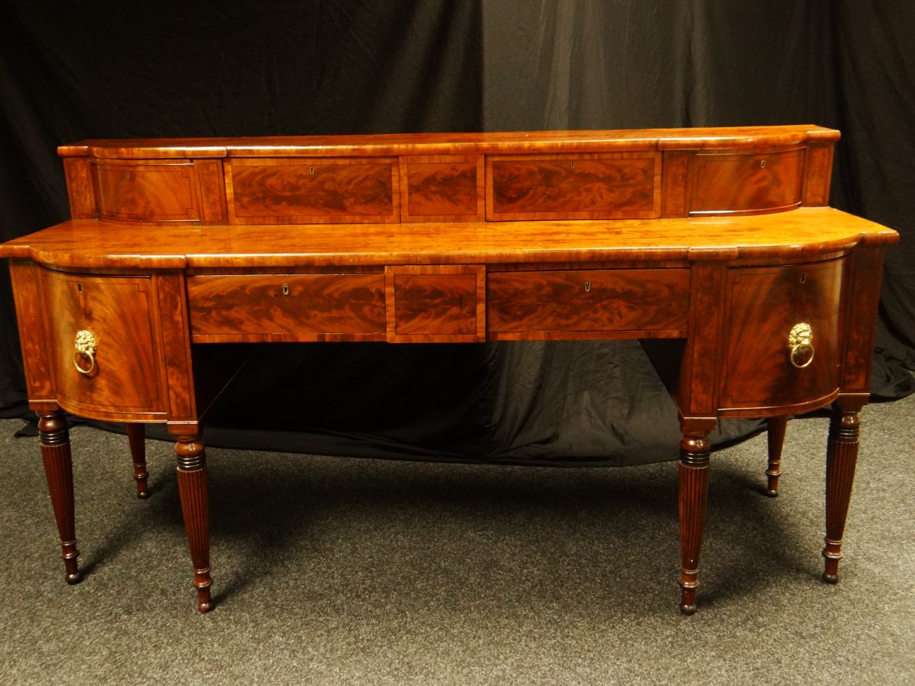 A fine William IV mahogany with boxwood stringing, Scottish breakfront sideboard, on four tapered