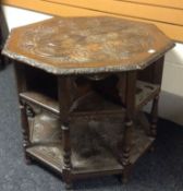 An heavily carved octagonal oak table, each facet having a central shelf over a base shelf, 35ins