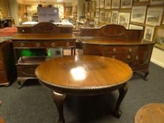 An Edwardian mahogany dining suite comprising a bow-front and rail-back mahogany dumb-waiter with