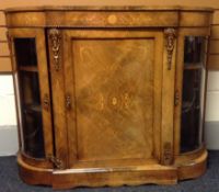 An ormolu mounted and inlaid walnut breakfront-credenza having a central cupboard flanked by two