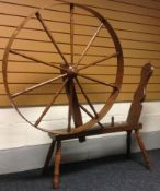 A Welsh oak and elm spinning wheel purported to be originally from John Ellis drapery of Penrhyn