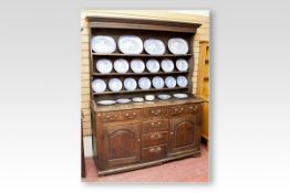 A late 18th/early 19th Century oak Merionethshire Welsh dresser having a three shelf rack with