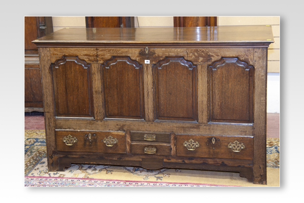 An antique oak Lancashire type chest having four fielded front panels with two long and two short