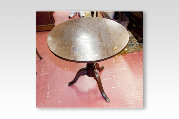 A 19th Century circular oak tilt-top tripod table