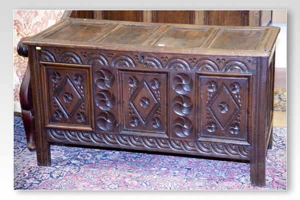 A late 18th Century oak dower chest, the hinged lid having four inset panels and the front with