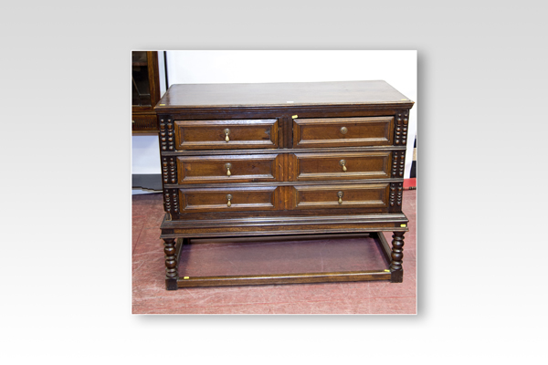 A 19th Century Jacobean style chest of two long and two short drawers on an open base with oblong