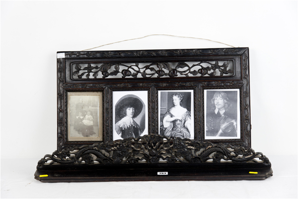 A carved dark hardwood four-window picture frame with similar period narrow shelf with carved