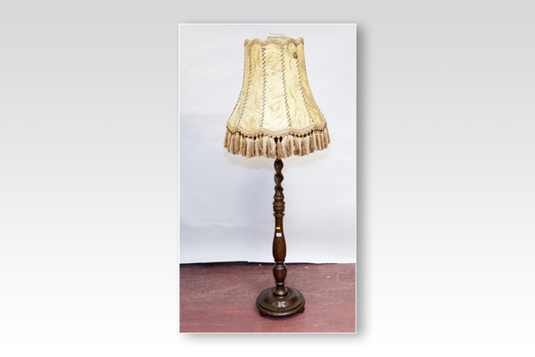 A polished standard lamp with barleytwist and shaped column and parchment shade