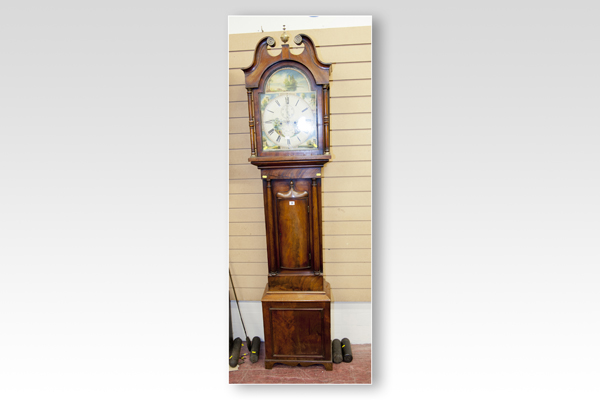 A mid 19th Century mahogany longcase clock having an arched hood with painted dial and eight day