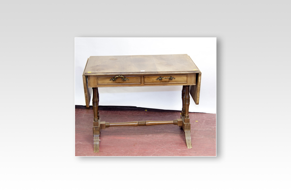 A reproduction mahogany twin flap sofa table with centre stretcher and two drawers (fading)