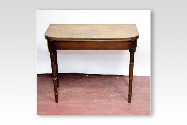 A Victorian mahogany fold-over tea table with turned supports