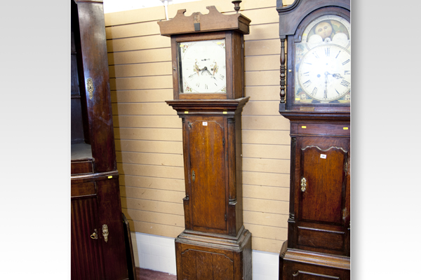 A late 18th/early 19th Century oak long case clock having square hood with painted dial, eight day
