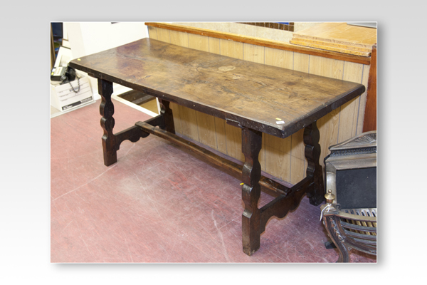 A dark oak oblong topped refectory style dining table, 71 x 25 ins (180 x 64 cms)