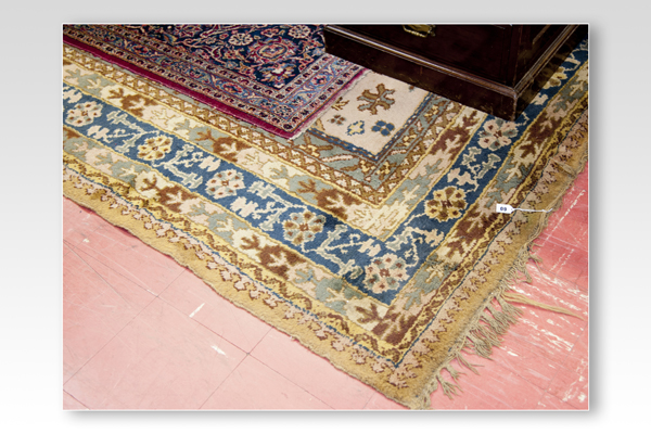 A large Eastern style carpet in blues and fawns having a seven row border, approximately 15 feet x