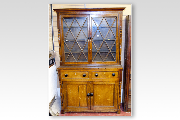 A 19th Century oak two piece Welsh cupboard, the upper section having twin glazed doors with