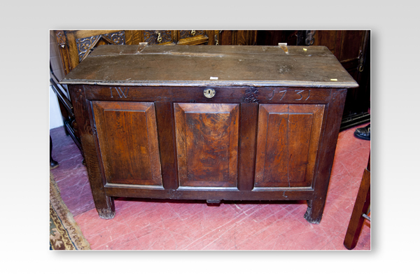 A late 18th/early 19th Century oak dower chest having a triple fielded panel front