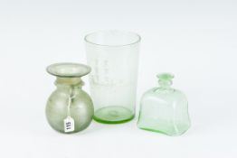 A green soda glass vase with etched naive scene of a ship; a green glass bottle; and an early