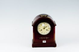 A mahogany encased dome topped bracket clock with eight day striking movement